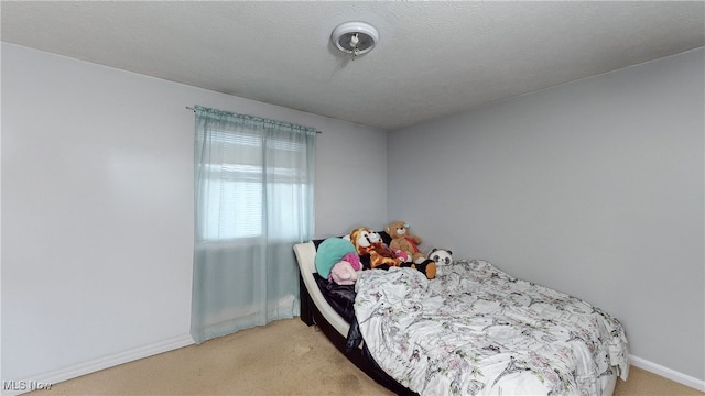 bedroom featuring carpet and a textured ceiling