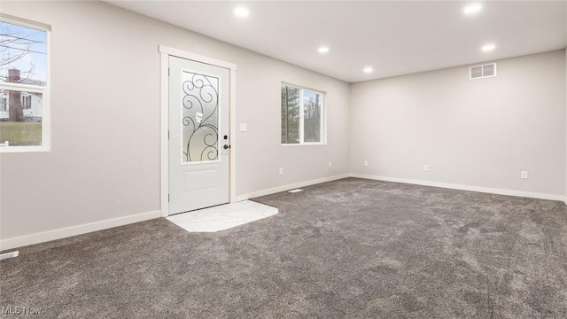 foyer entrance with dark colored carpet