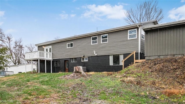 back of house featuring a wooden deck