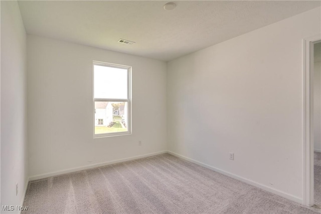 spare room featuring carpet floors