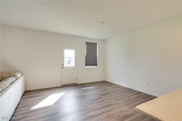 unfurnished living room featuring wood-type flooring