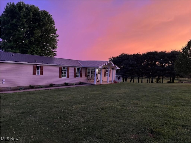 view of front facade with a patio area and a lawn