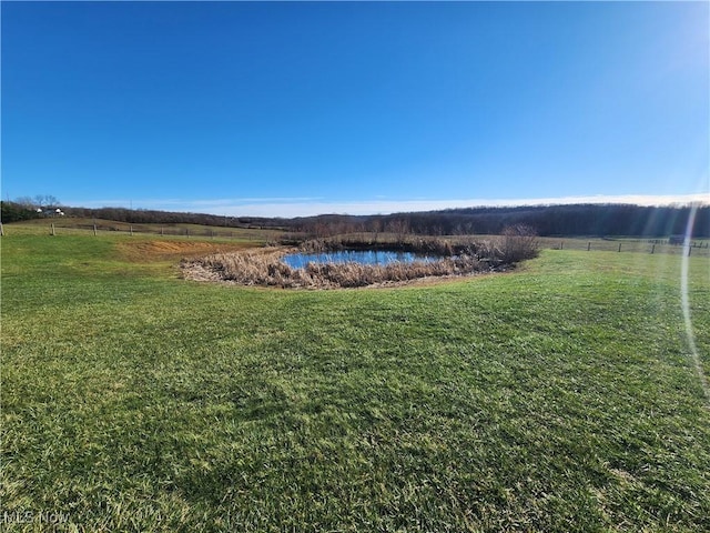 view of yard with a rural view and a water view