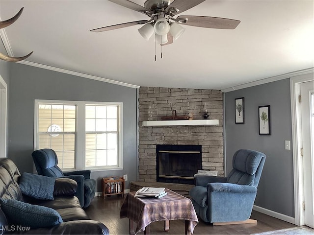 living room featuring ornamental molding, vaulted ceiling, ceiling fan, hardwood / wood-style flooring, and a fireplace