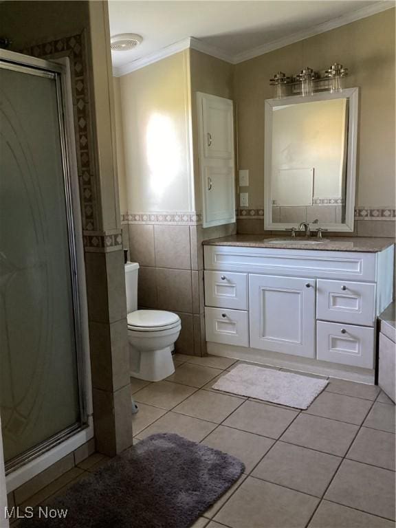 bathroom featuring crown molding, tile patterned flooring, vanity, and tile walls