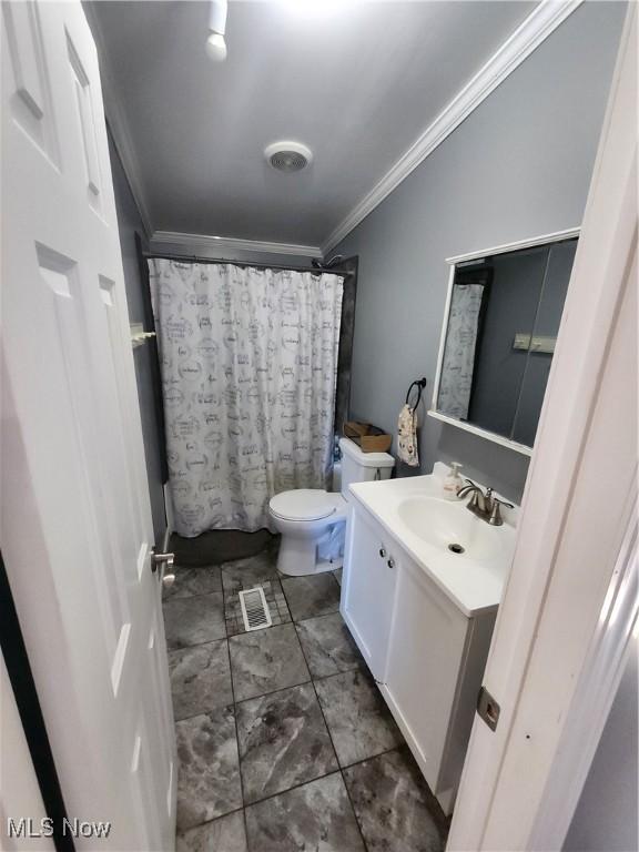 full bathroom featuring shower / bath combination with curtain, vanity, toilet, and crown molding