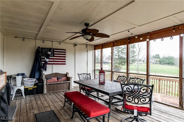 sunroom featuring ceiling fan