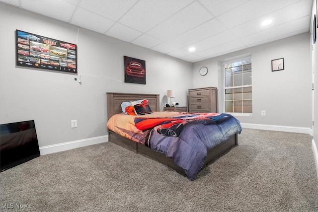 carpeted bedroom featuring baseboards, recessed lighting, and a drop ceiling