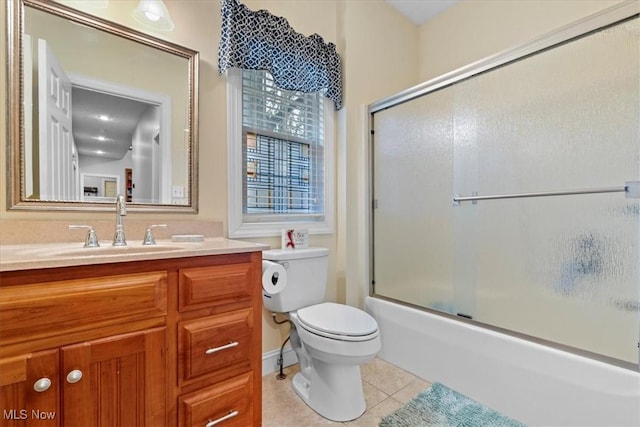bathroom with vanity, toilet, enclosed tub / shower combo, and tile patterned flooring