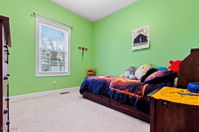 bedroom with visible vents, carpet floors, and baseboards