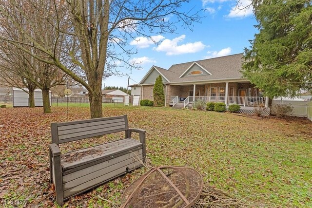 view of community with fence and a yard