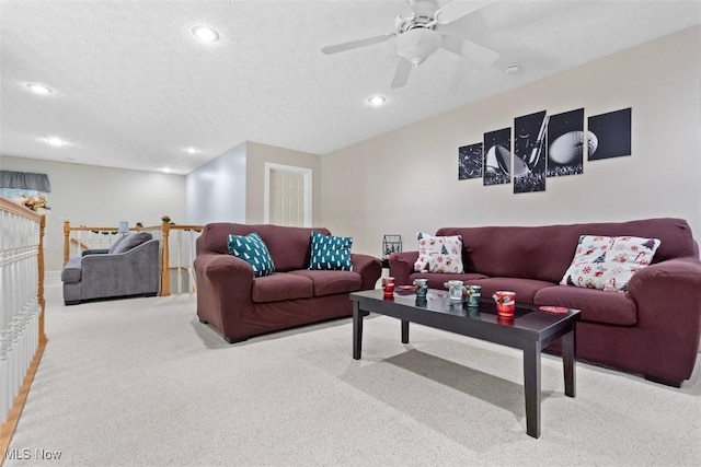 carpeted living room with baseboards, recessed lighting, ceiling fan, and a textured ceiling