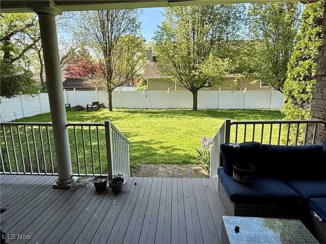 deck featuring a yard and a fenced backyard