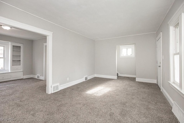 spare room with carpet floors and plenty of natural light