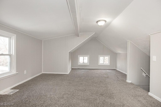 additional living space with carpet floors and lofted ceiling with beams