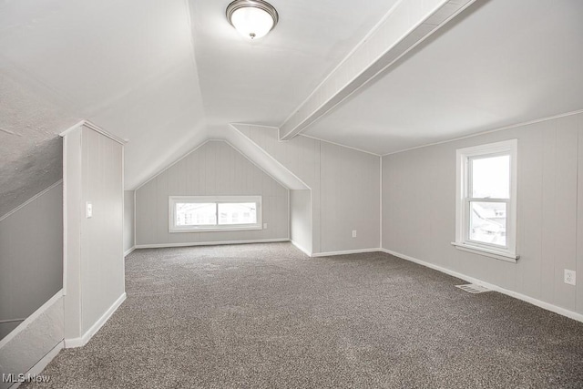 bonus room with carpet floors and lofted ceiling with beams