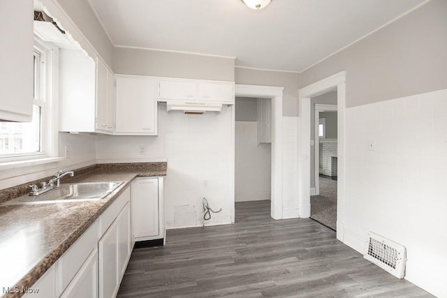 kitchen featuring white cabinets, dark hardwood / wood-style floors, and sink