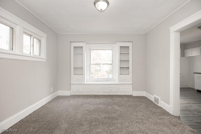 empty room featuring dark colored carpet