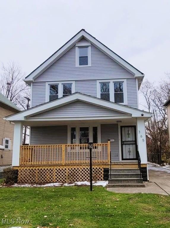 365 E 123rd St, Cleveland, OH 44108 - view of front of property featuring covered porch and a front yard