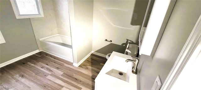365 E 123rd St, Cleveland, OH 44108 - bathroom featuring bathing tub / shower combination, sink, and wood-type flooring