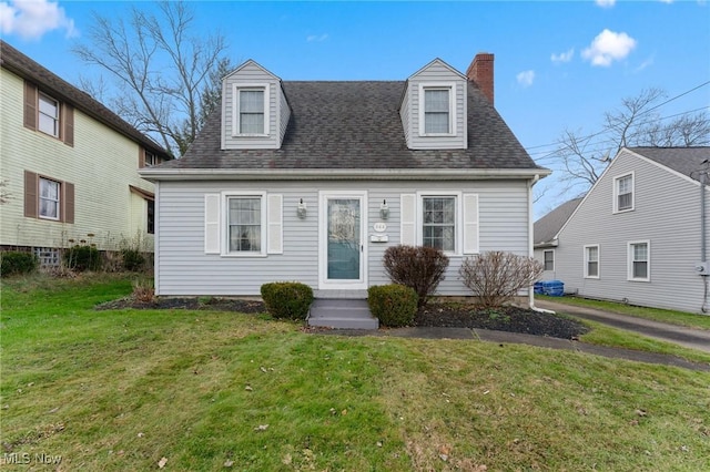 cape cod house with a front lawn