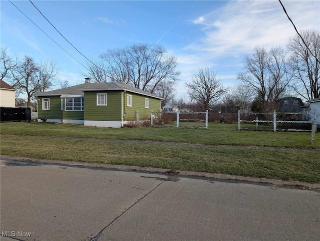 view of side of property with a yard