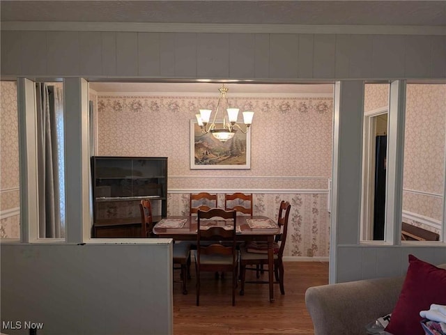 dining area featuring hardwood / wood-style floors and a notable chandelier