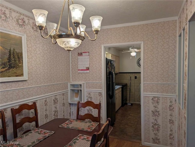 dining area with a textured ceiling, crown molding, ceiling fan with notable chandelier, and hardwood / wood-style flooring