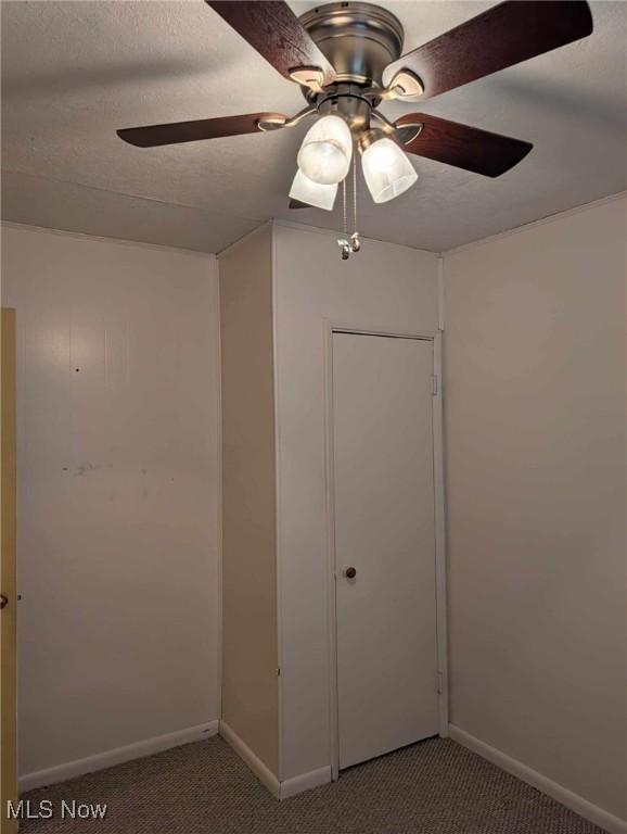 unfurnished bedroom featuring carpet flooring, ceiling fan, and a closet