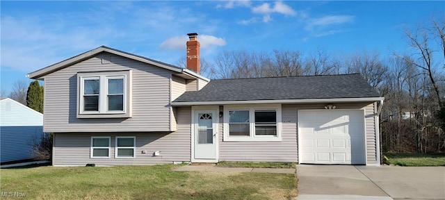 split level home with a front yard and a garage