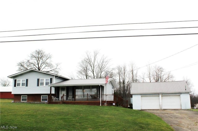 split level home featuring a porch, a garage, an outdoor structure, and a front lawn