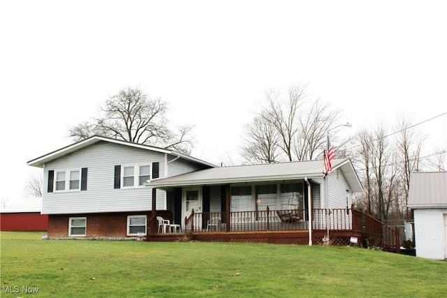 tri-level home with a front yard and covered porch