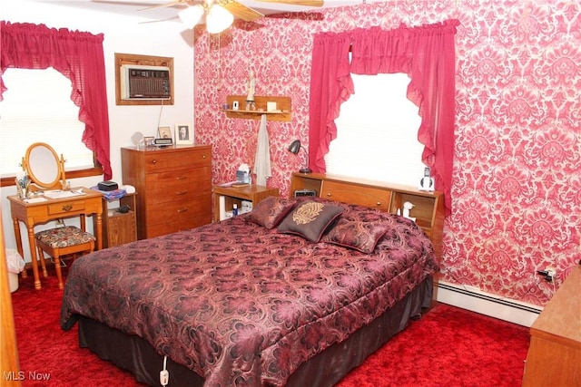 carpeted bedroom with ceiling fan, an AC wall unit, and baseboard heating