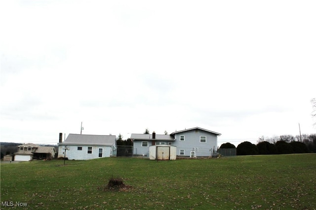 exterior space featuring a lawn and a storage shed