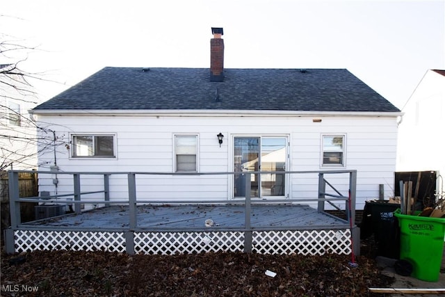 rear view of property featuring a wooden deck