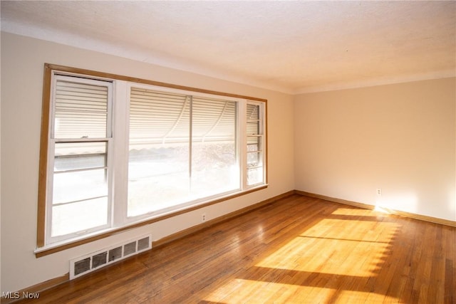 empty room featuring hardwood / wood-style floors and a textured ceiling