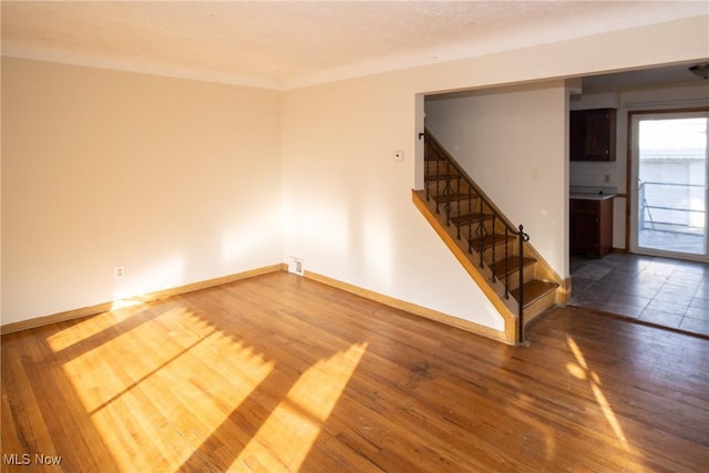 unfurnished room with hardwood / wood-style floors