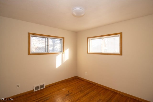 spare room featuring hardwood / wood-style floors