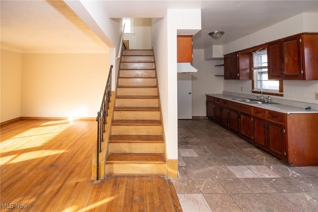 kitchen with backsplash, hardwood / wood-style flooring, and sink