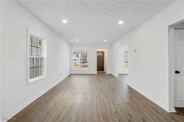 interior space with wood-type flooring and a textured ceiling