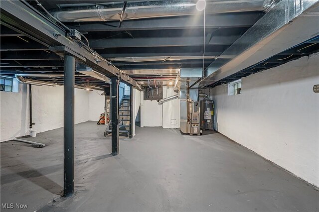 basement featuring heating unit and gas water heater