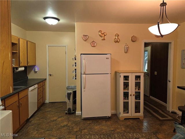 kitchen with white appliances and hanging light fixtures