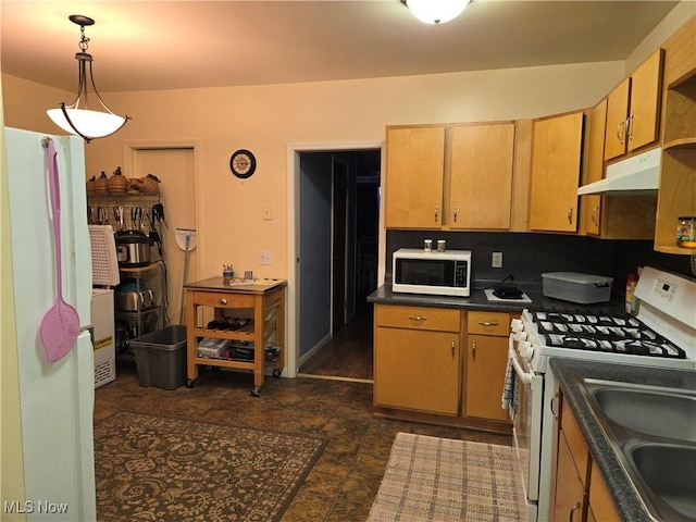 kitchen with decorative backsplash, sink, pendant lighting, and white appliances