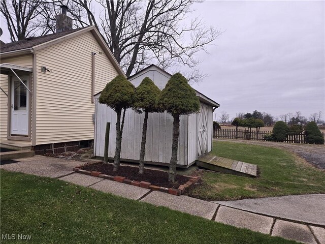 view of property exterior featuring a yard and a shed