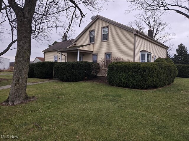 view of home's exterior with a lawn