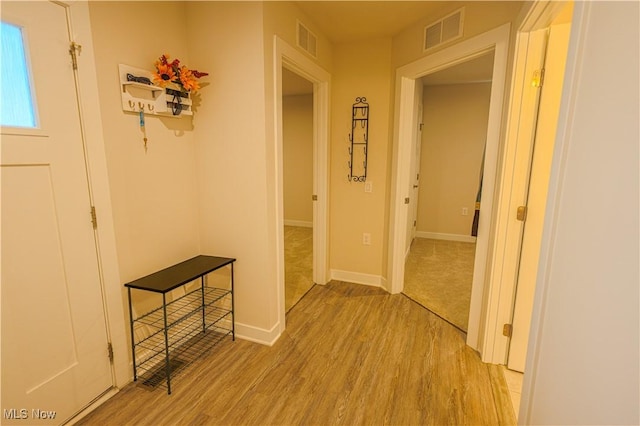 corridor with light hardwood / wood-style flooring