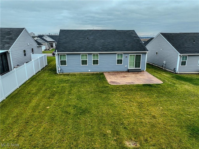 rear view of property with a yard and a patio