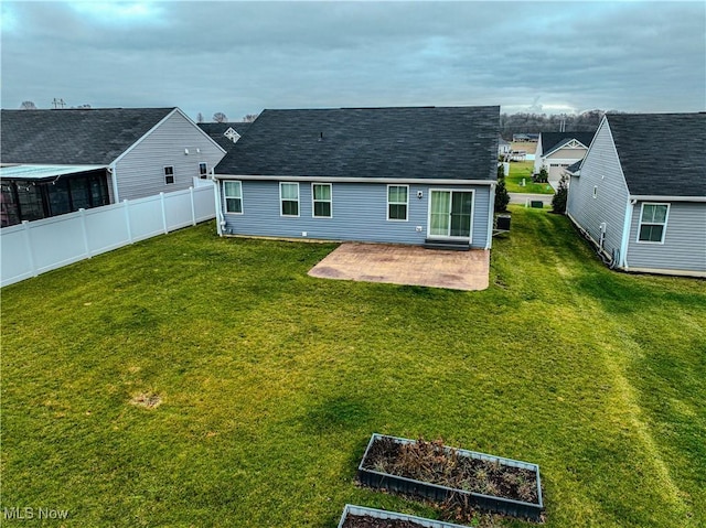 back of property with a patio area and a lawn