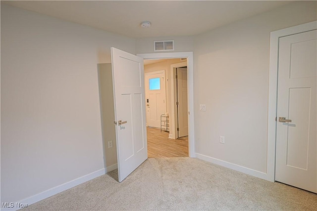 unfurnished bedroom with light colored carpet