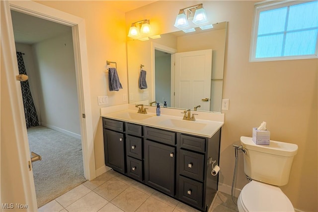 bathroom featuring tile patterned floors, vanity, and toilet